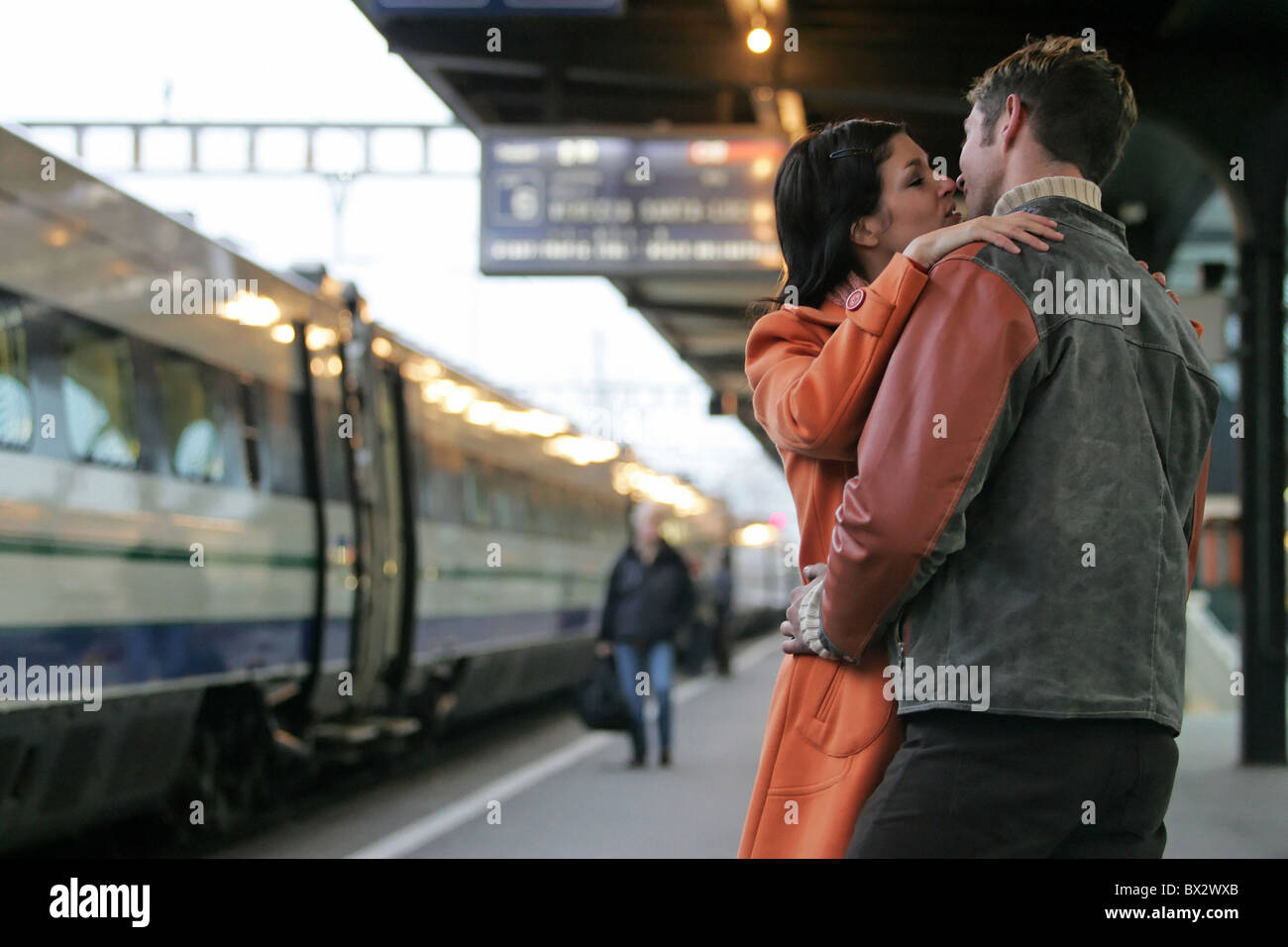 couple resignation kissing kiss train railway railroad traveling reunion  railway station Geneva Switzerland Stock Photo - Alamy