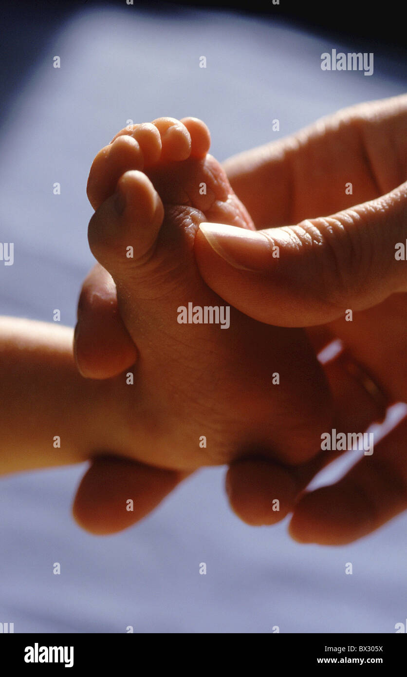 baby feet toes foot hand mother child affection tenderness affectionate detailed admission detail close-up Stock Photo