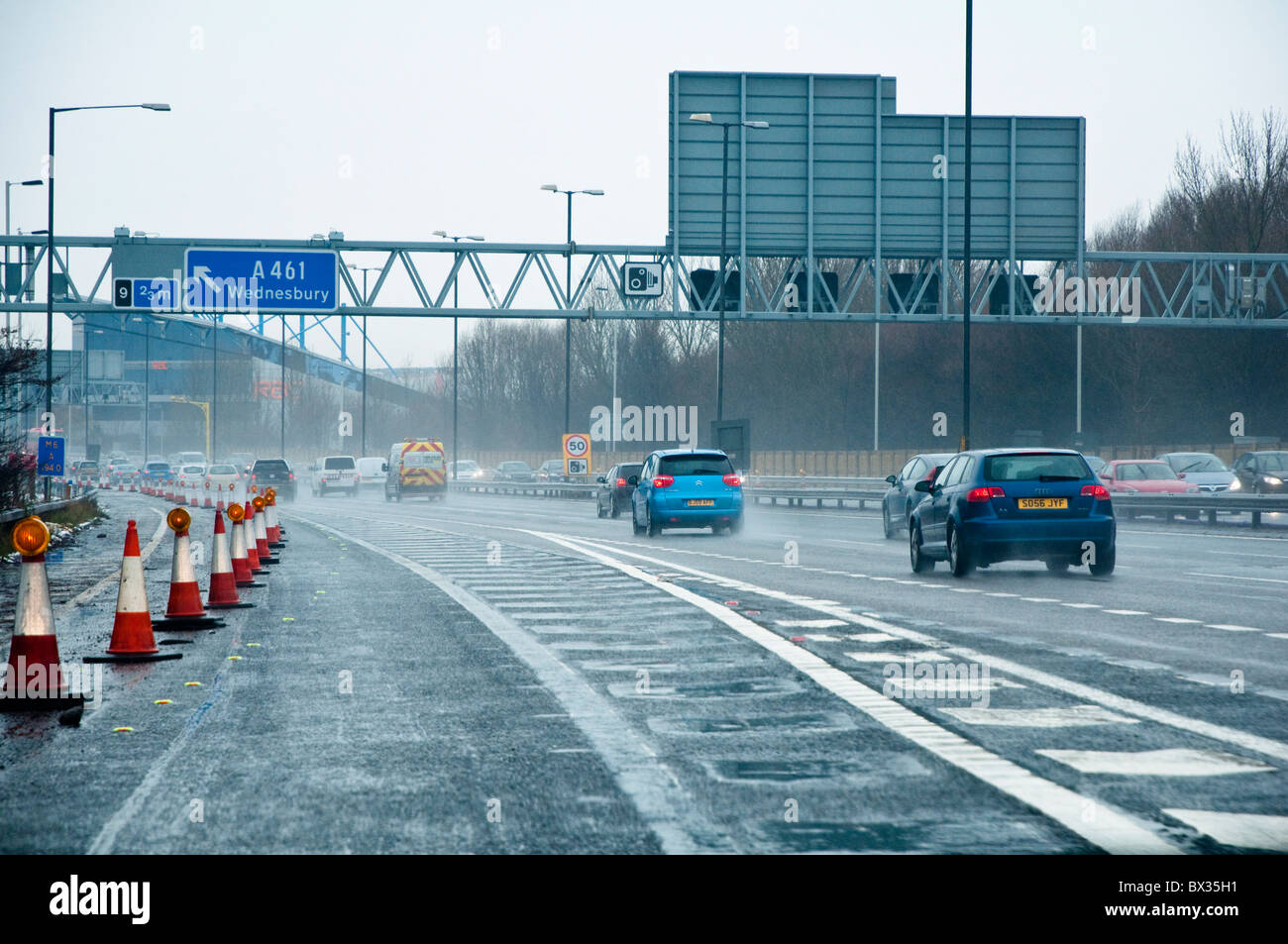 Junction 8, where the M5, joins the M6 motorway. Drivers viewpoint on a grey wintry day, showing spray and poor visibility. UK Stock Photo