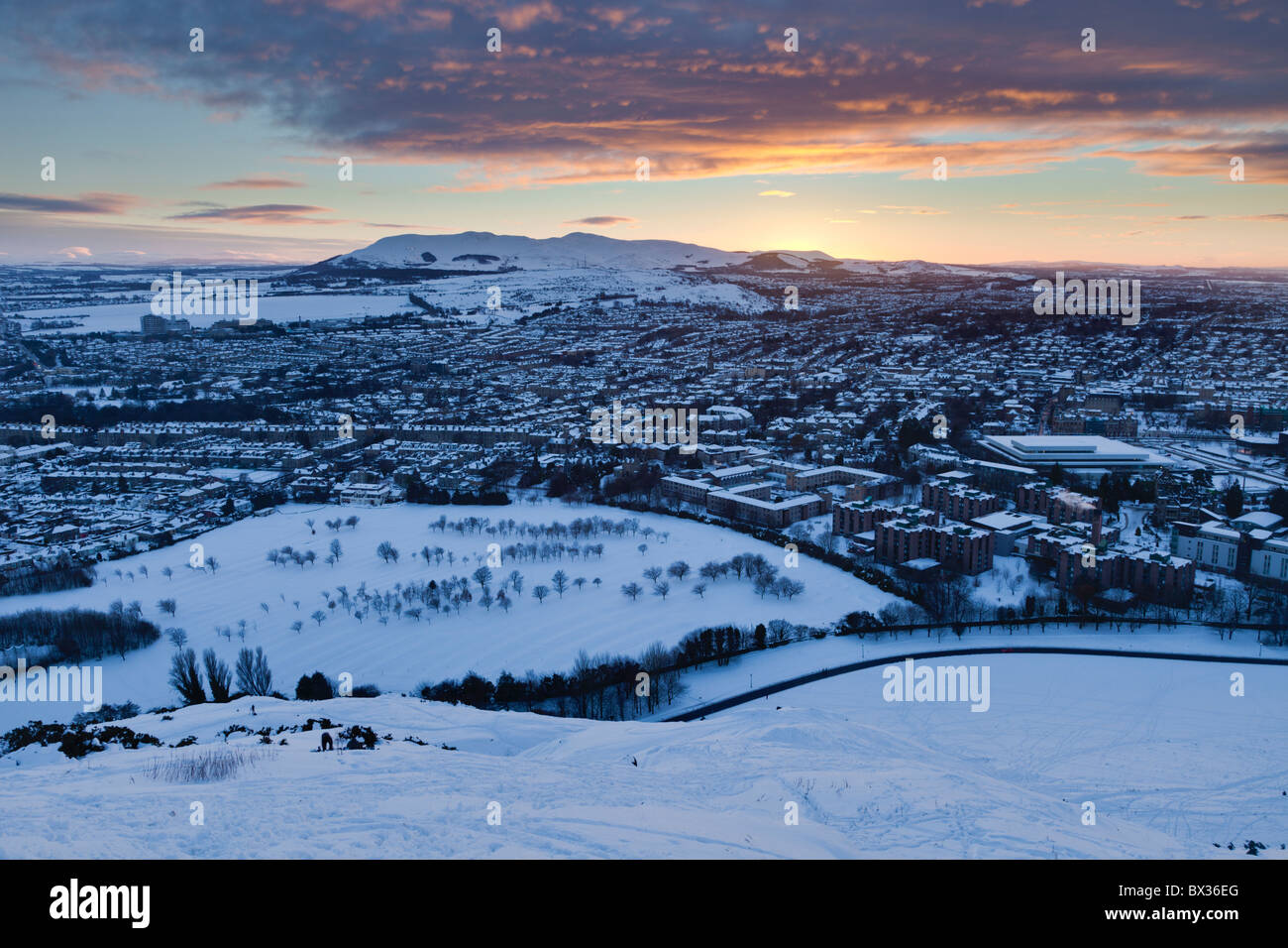 Looking over a snowy Edinburgh to Hillend and the Pentlands at sunset
