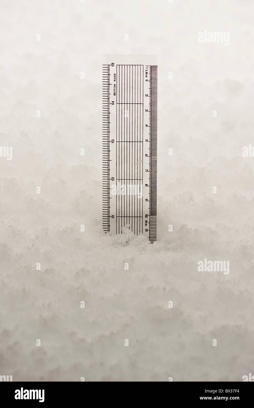 Transparent plastic ruler showing depth of snow 10 inches Stock Photo