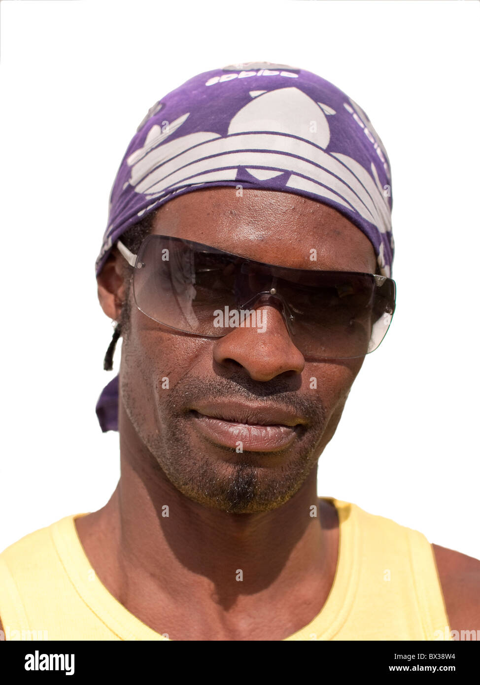 Booma age 40 from Leeds, Black male Afro-Caribbean wearing yellow T shirt and purple head scarf. Stock Photo