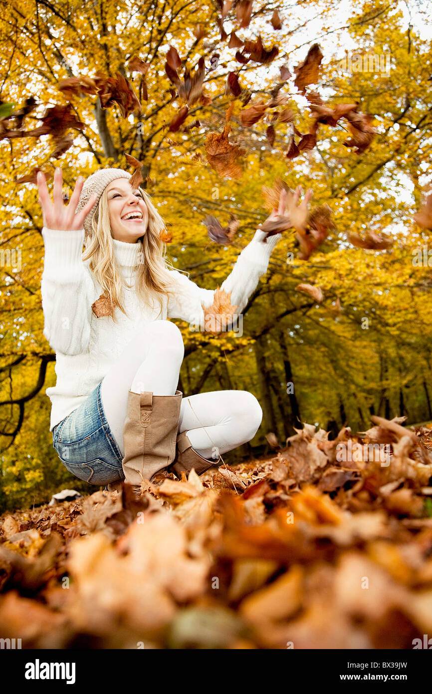 teenage girl in park playing with autumn leaves Stock Photo - Alamy