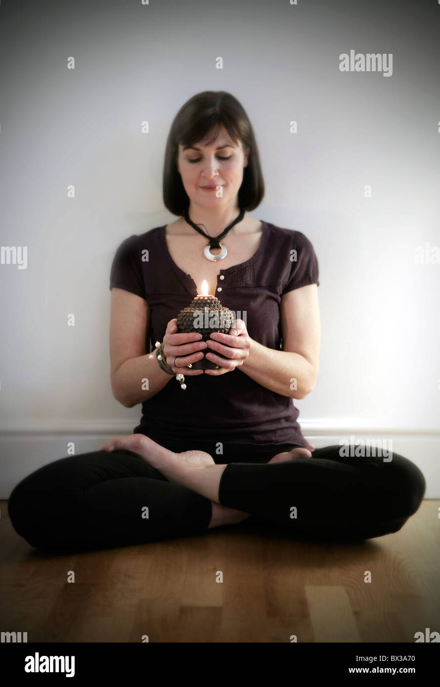 Yoga teacher in mindfulness posture Stock Photo