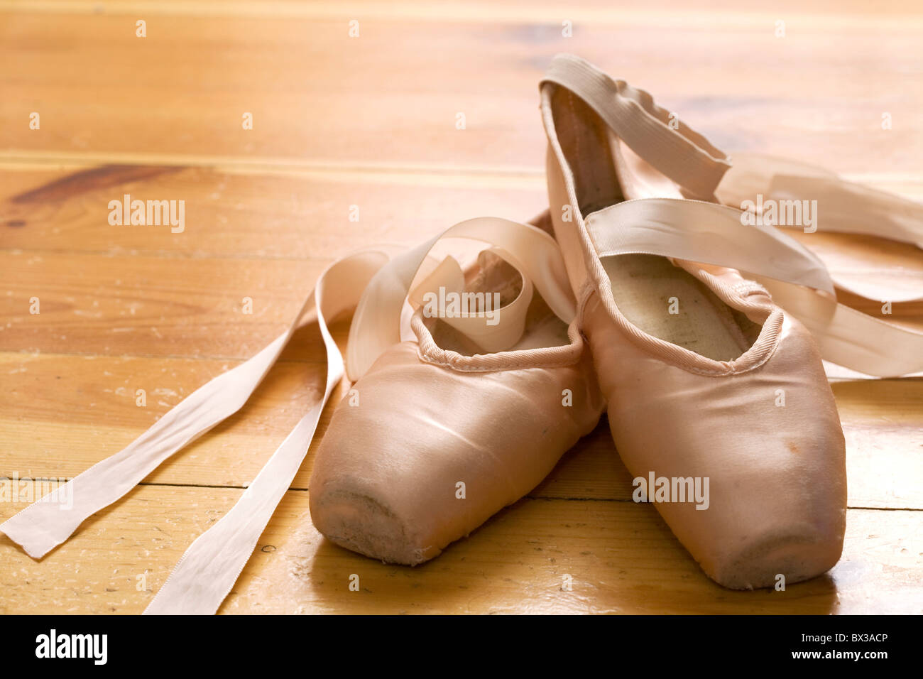 pair of ballet shoes on wooden floor Stock Photo