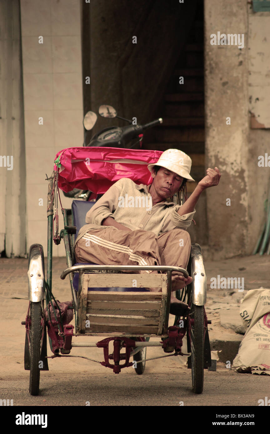 rickshaw driver resting. Stock Photo