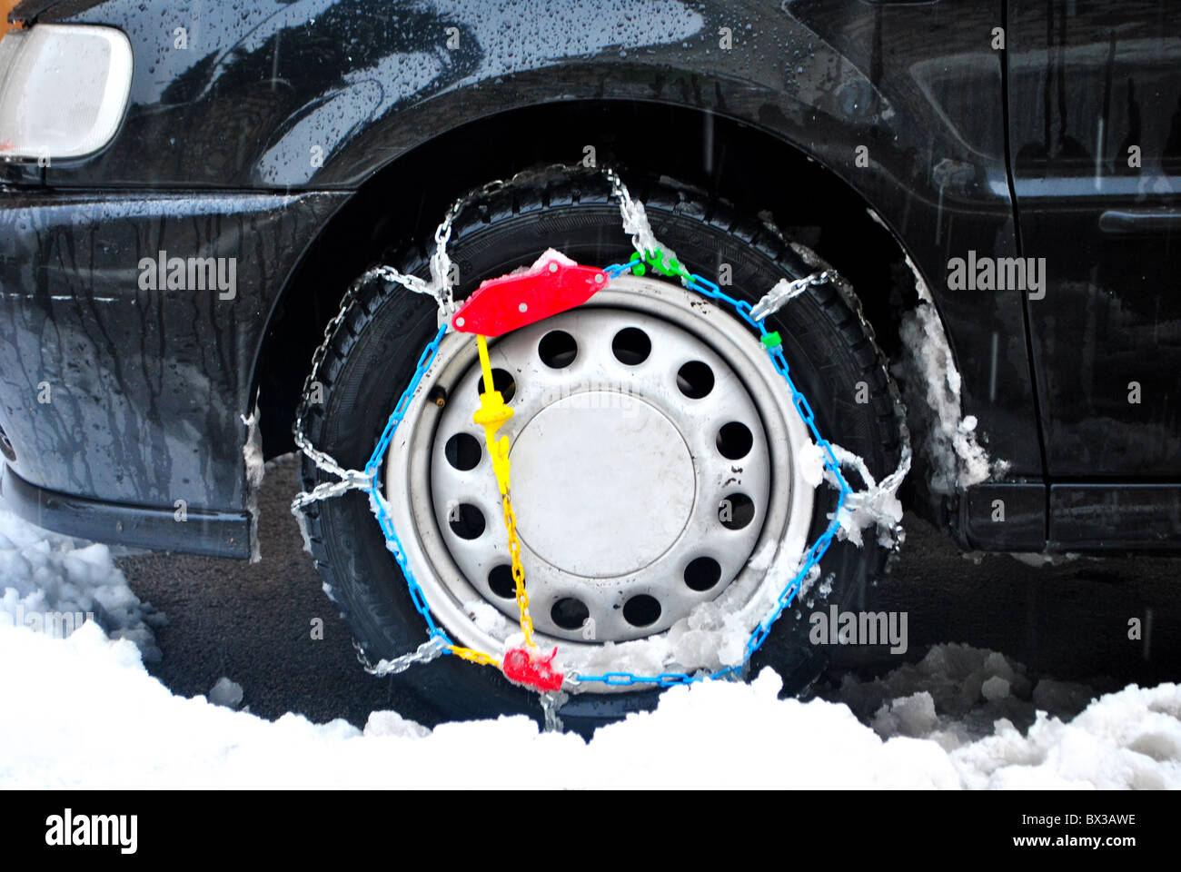 wheel with snow chains Stock Photo Alamy