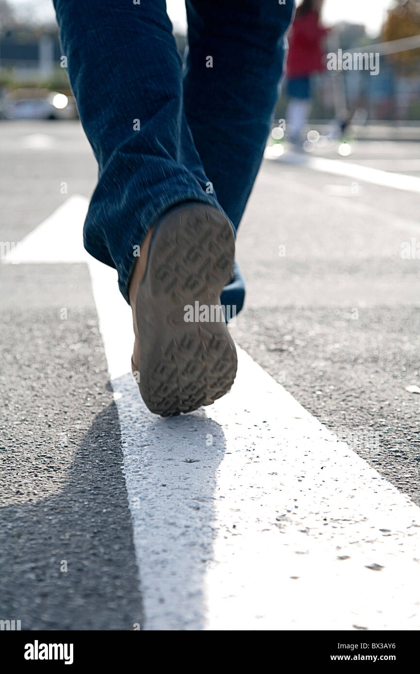 rear view of man walking in the street Stock Photo