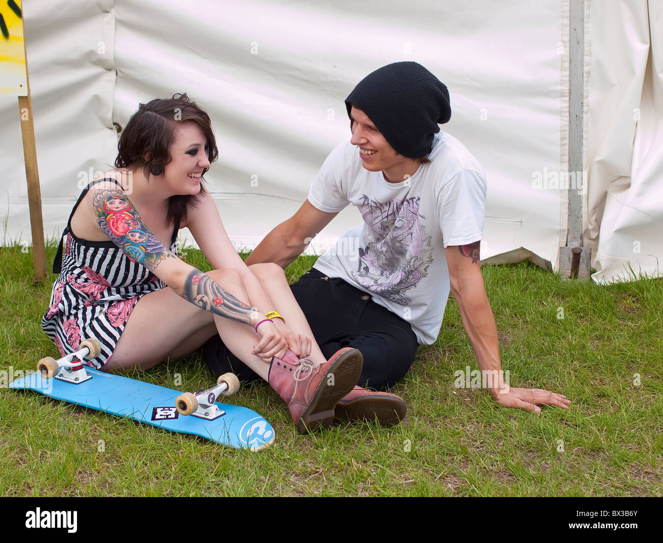 Lucy a trendy young female adult nineteen year old with tattoos with boy friend Blair (real people) at youth festival Stock Photo