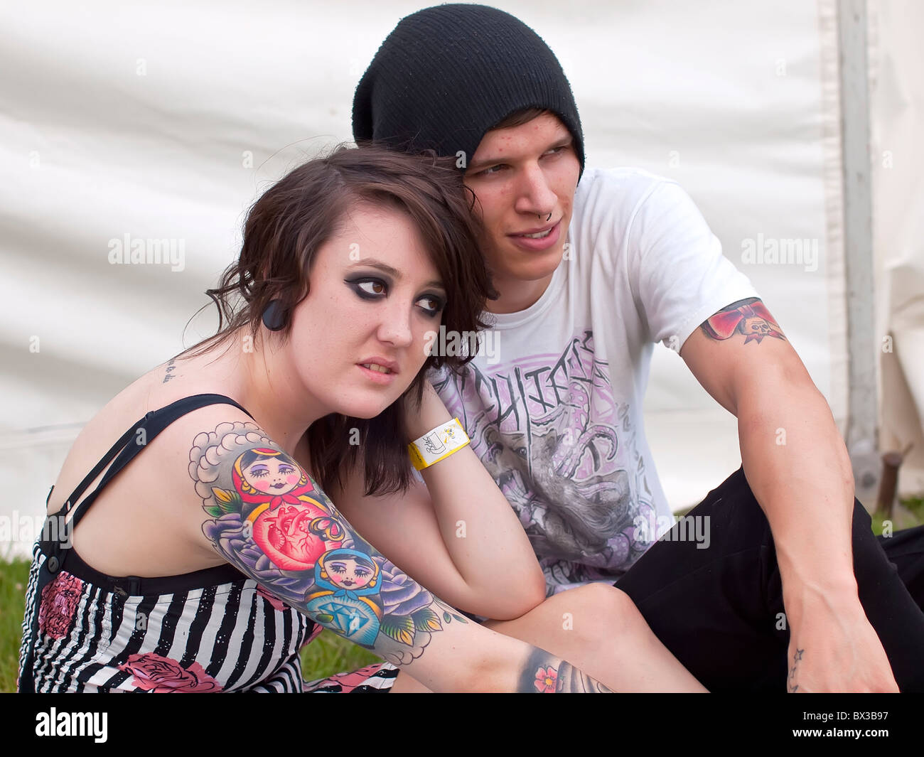Lucy a trendy young female adult nineteen year old with tattoos with boy friend Blair (real people) at youth festival Stock Photo