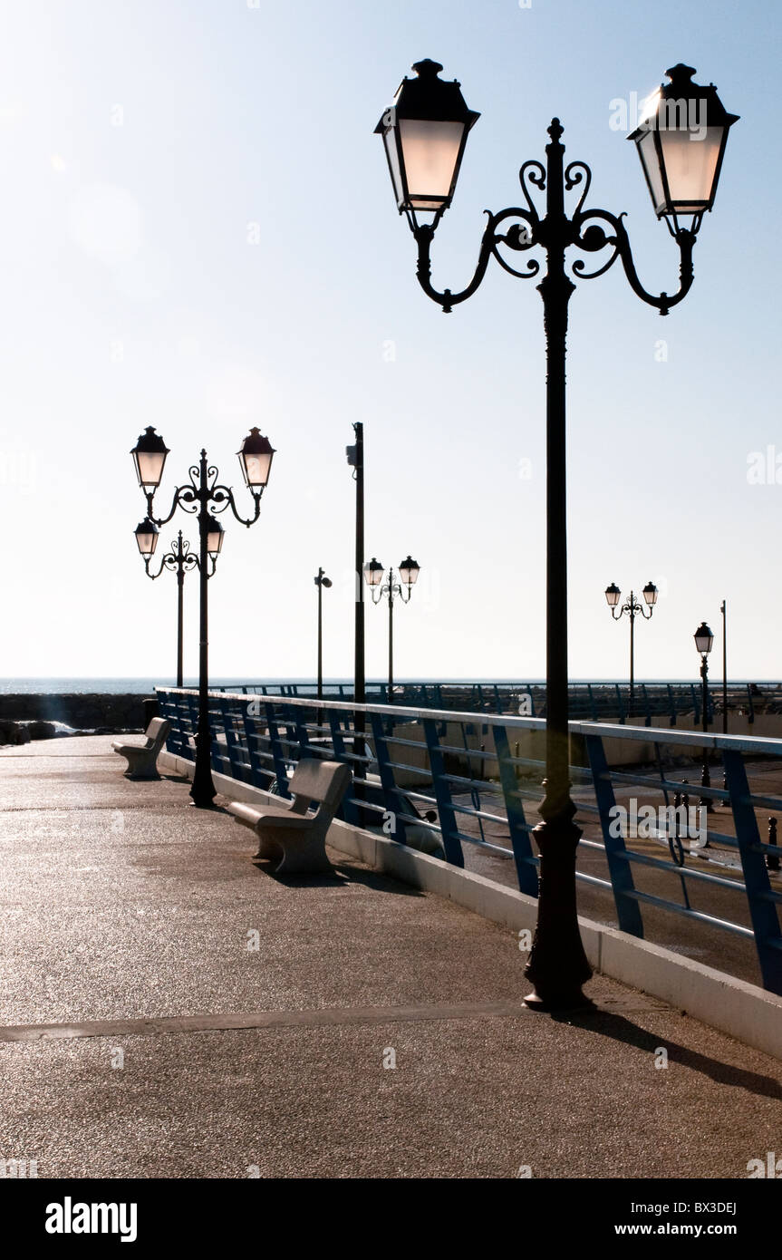 Lampposts on the waterfront promenade, Saintes-Maries-de-la-Mer, Southern France Stock Photo