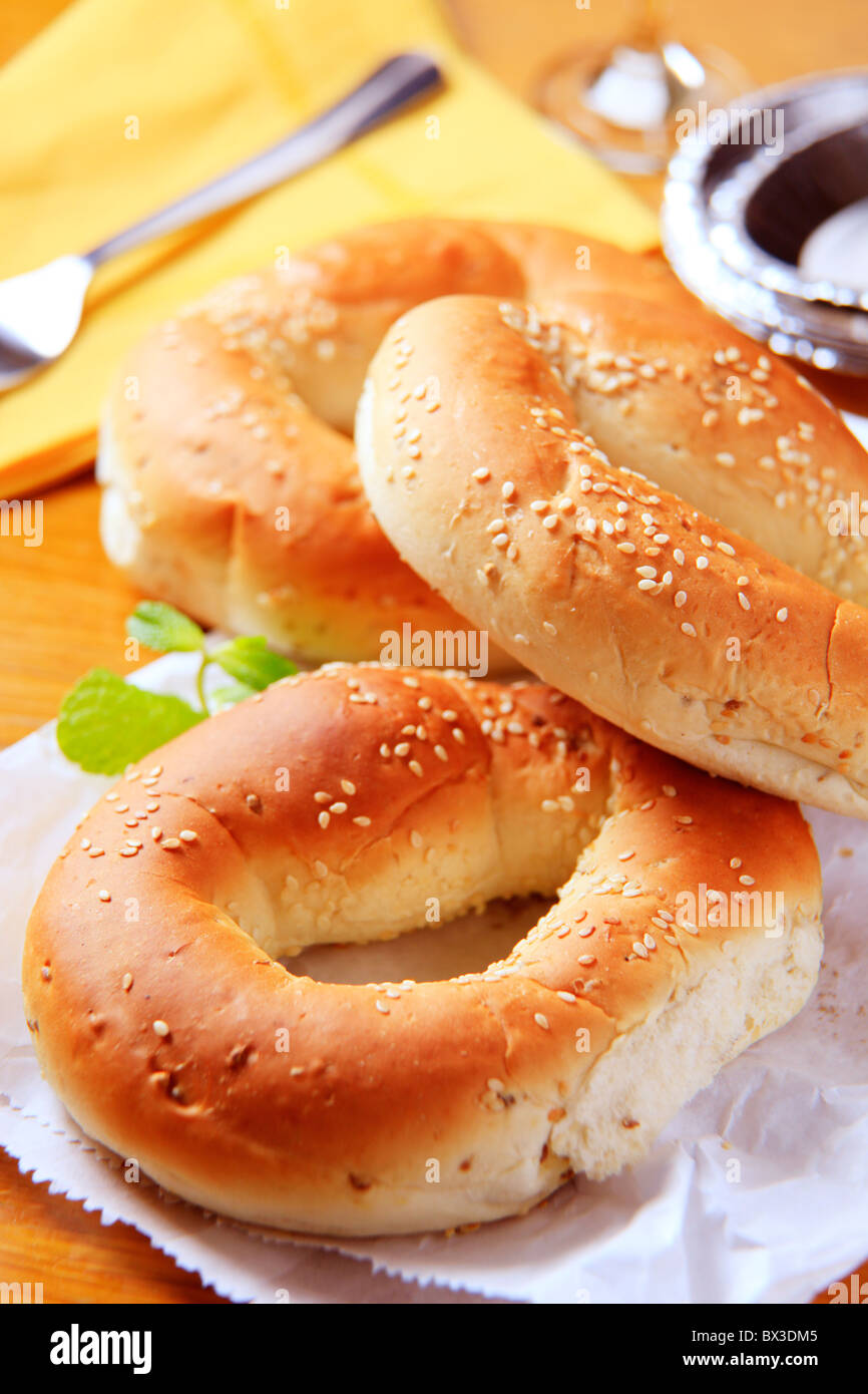 Three sesame seed bagels on a paper bag Stock Photo