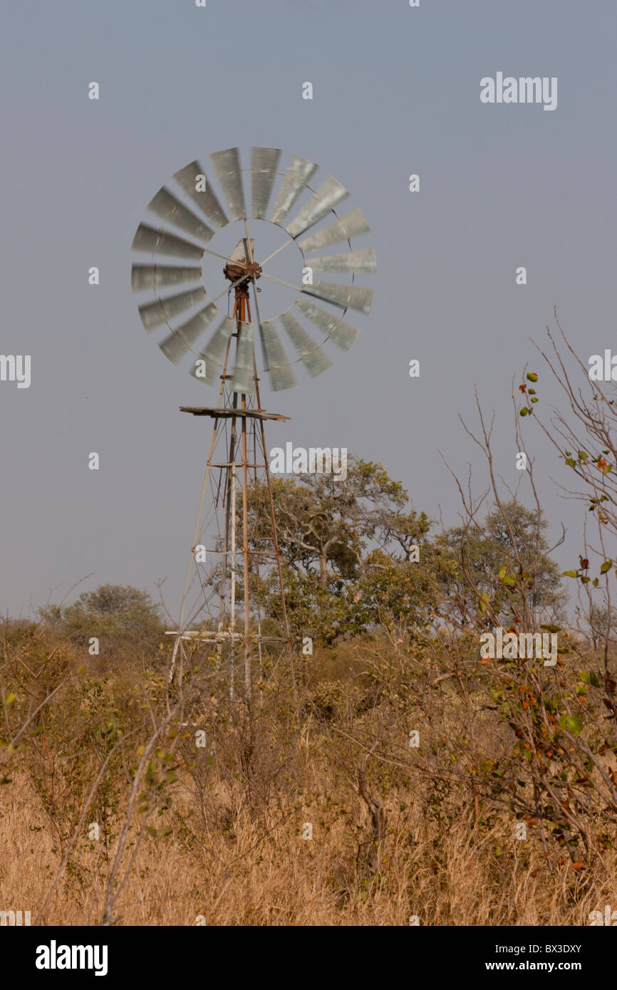 Waterpump driven by a windmill and supplying a waterhole. The photo was taken in Kruger National Park, South Africa. Stock Photo