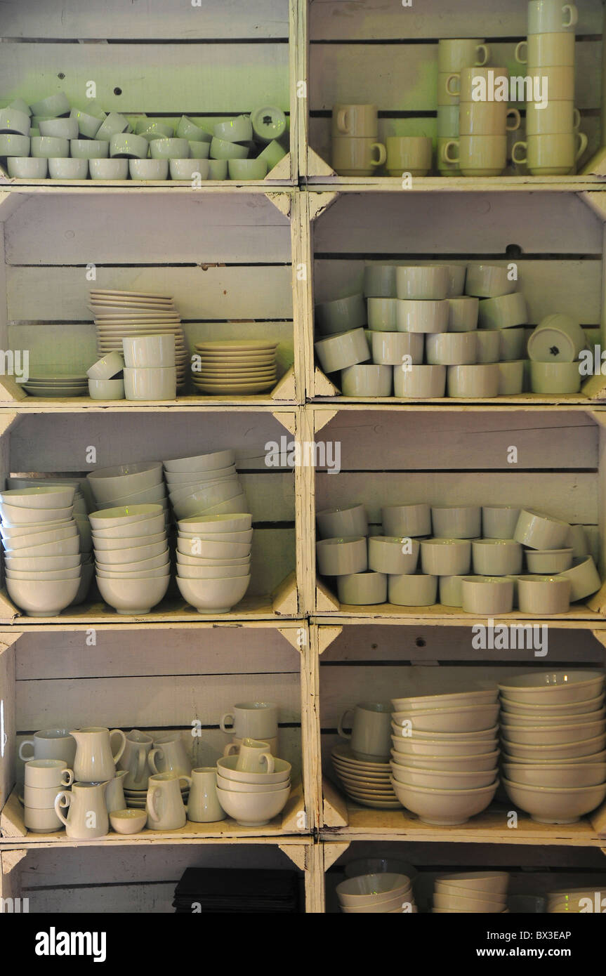 A selection of crockery bowls, plates and jugs stacked on simple