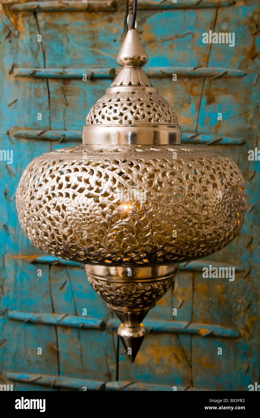 A metal middle-eastern style lamp hanging against a blue background Stock  Photo - Alamy
