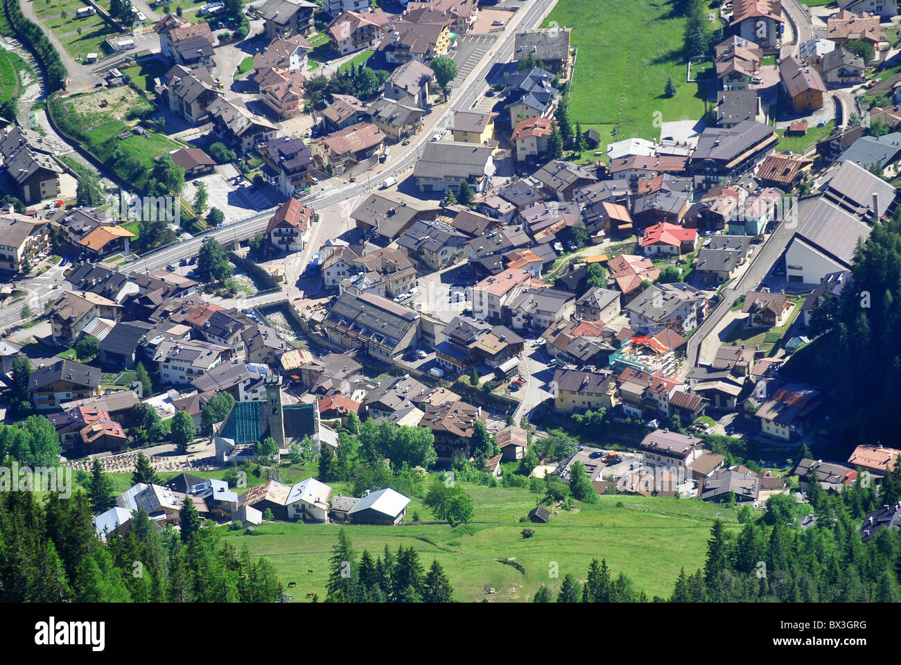small town in mountain valley with green pine Stock Photo - Alamy