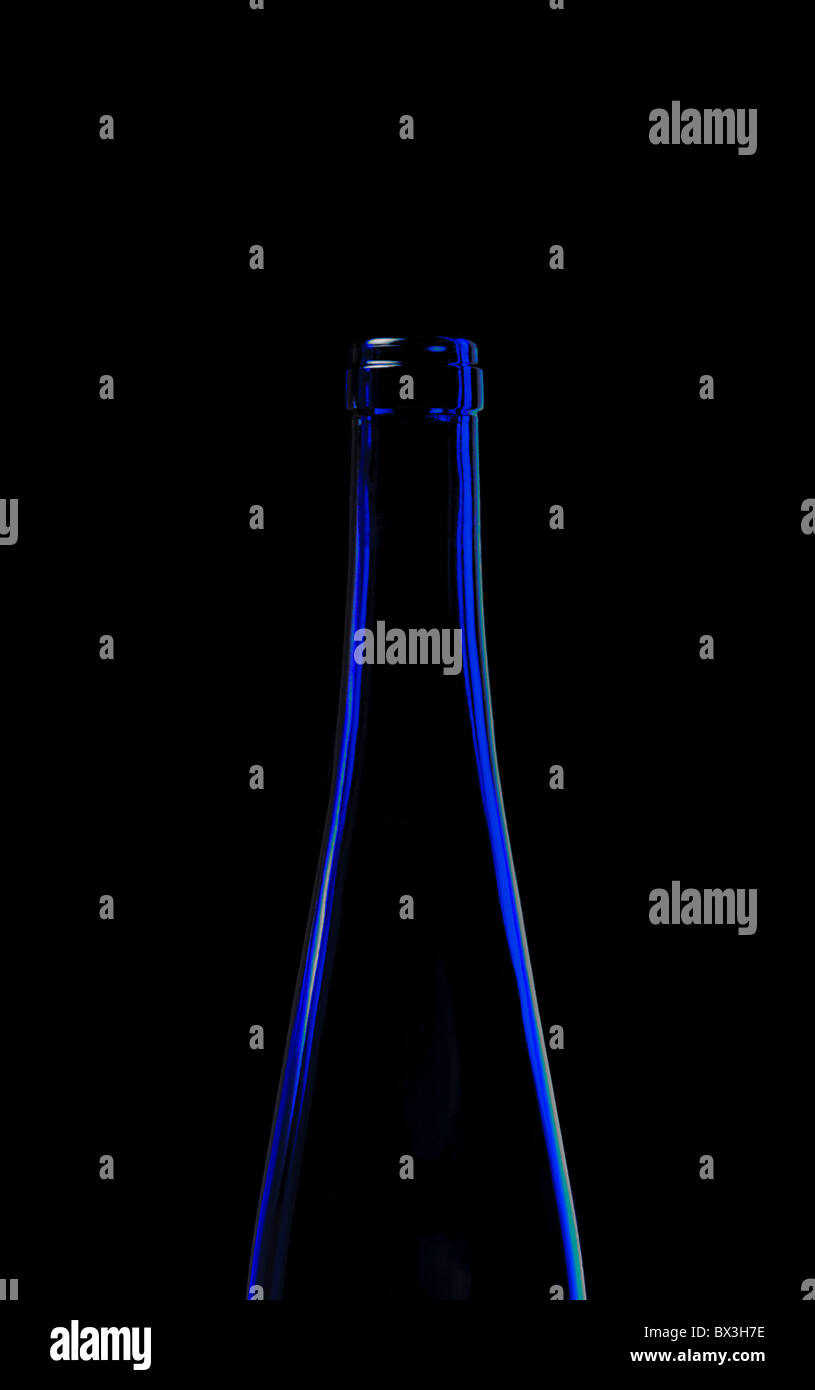 Minimalist still life of blue wine bottle against a black background Stock Photo