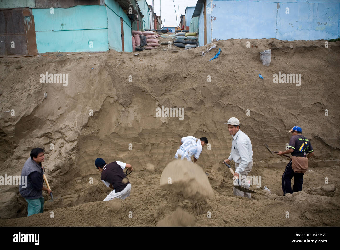 Men fight erosion in the peublo joven of Villa el Salvador, Lima - Peru. Stock Photo