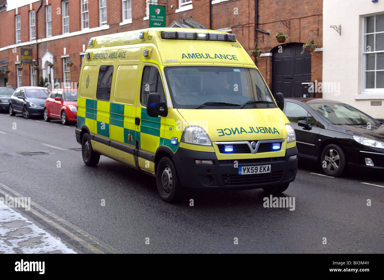Ambulance on emergency call in town centre, Warwick, UK Stock Photo