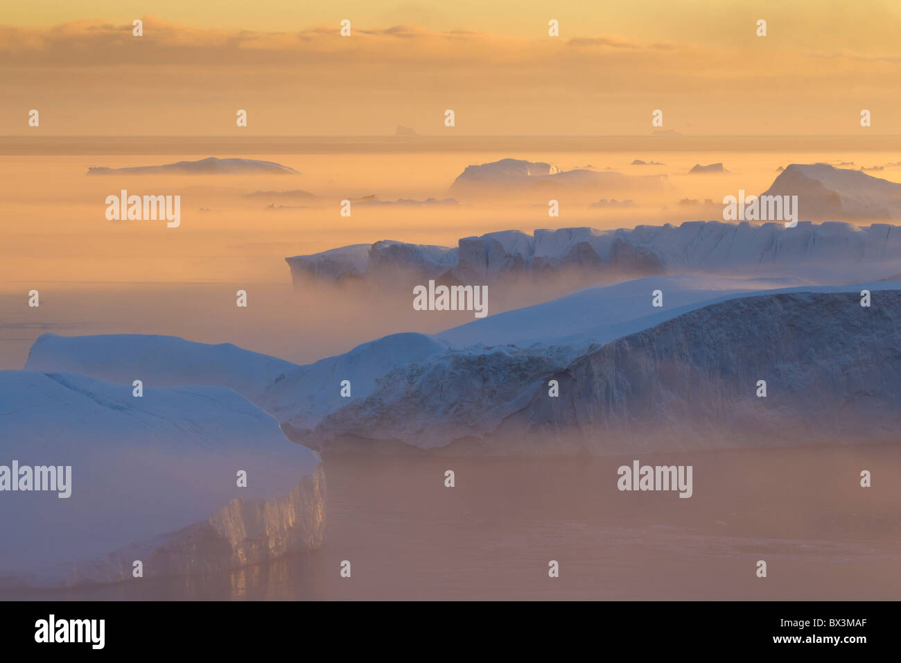 Icebergs in the mist, on UNESCO’s World Heritage List, at sunset, Kangia icefjord, Disko-Bay, West-Greenland, Greenland Stock Photo