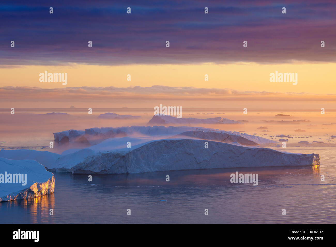 Icebergs in the mist, on UNESCO’s World Heritage List, at sunset, Kangia icefjord, Disko-Bay, West-Greenland, Greenland Stock Photo