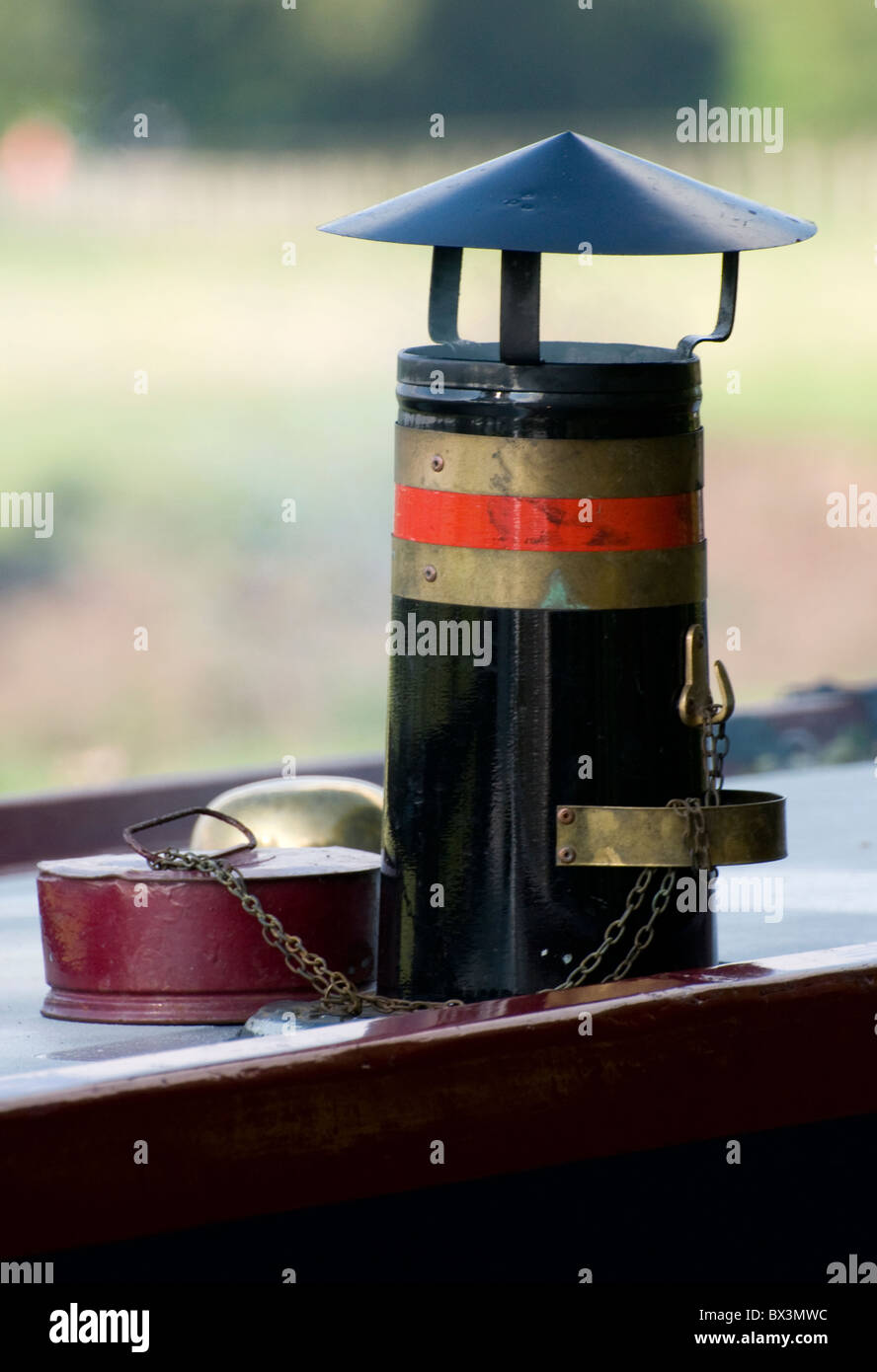 Ornate Chimney/Flue Flu on top of a river canal narrow boat barge - red/gold/glack with chimney covering and chain Stock Photo
