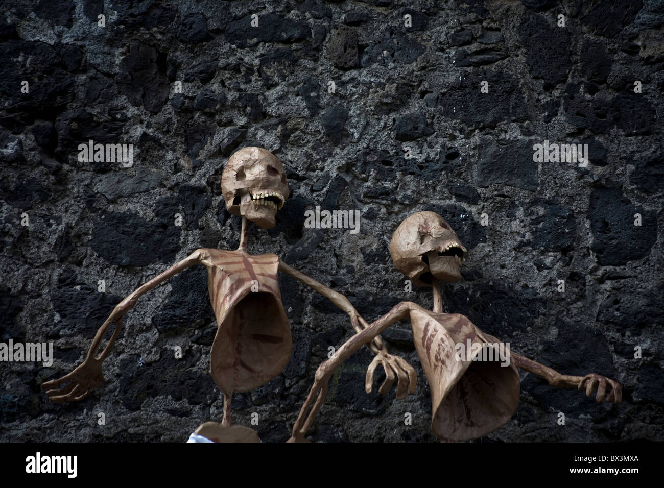 Paper skeletons hang on a wall during preparations for the Day of the Dead celebrations in Coyoacan, Mexico City Stock Photo