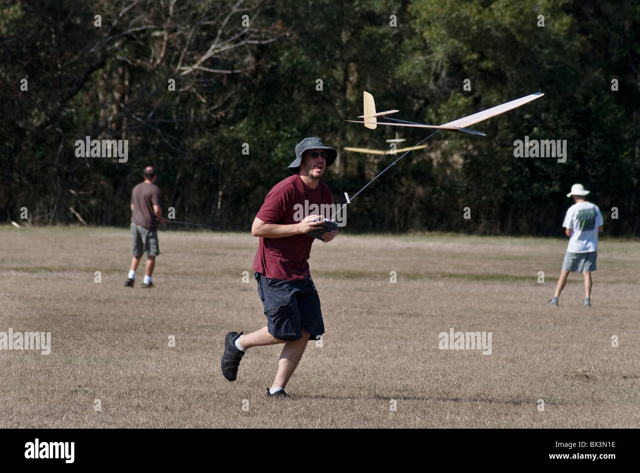 man chases his radio controlled hand launch glider during competition, Alachua, Florida. Stock Photo
