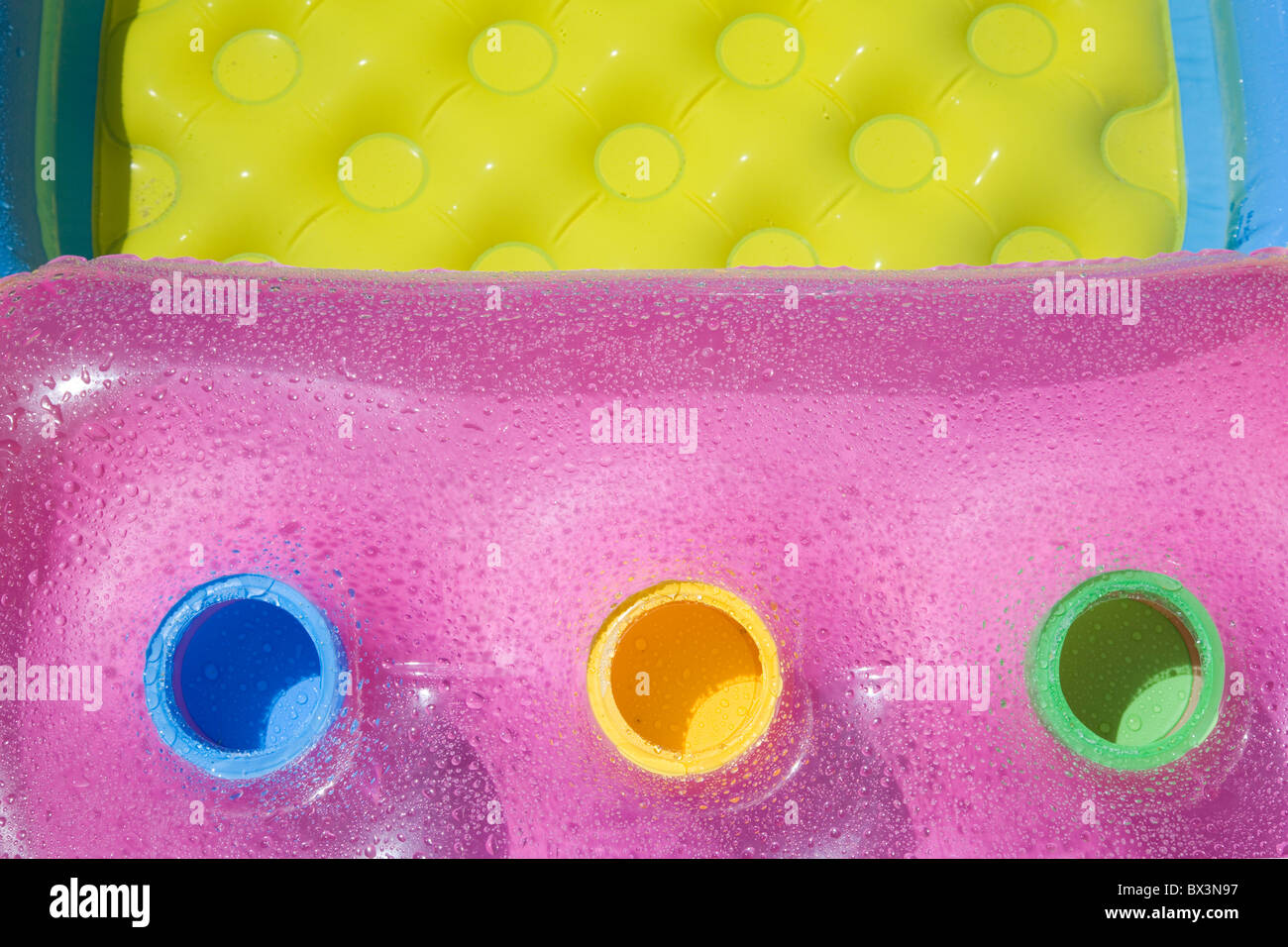 Air-bed and pool with fresh colors and water-drops Stock Photo