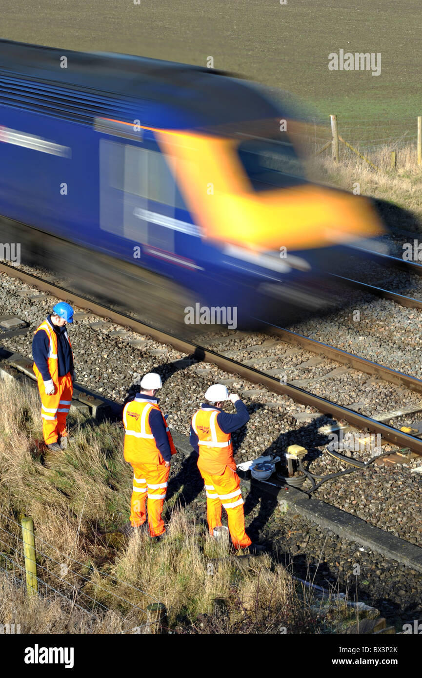 Network Rail workers stand clear of a train on the Great Western Mainline in Wiltshire. Stock Photo