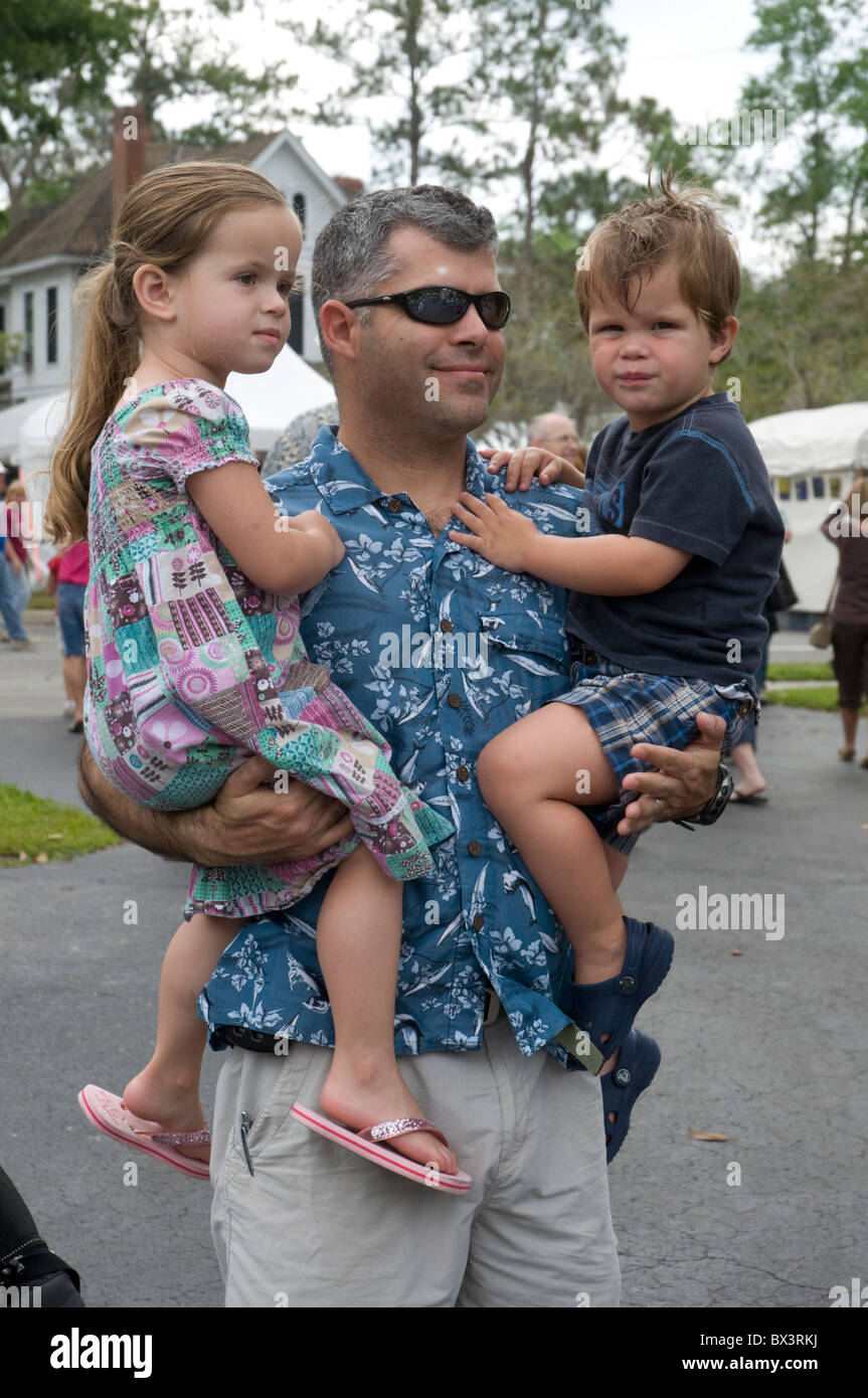 spring arts festival Gainesville Florida father carries his children Stock Photo