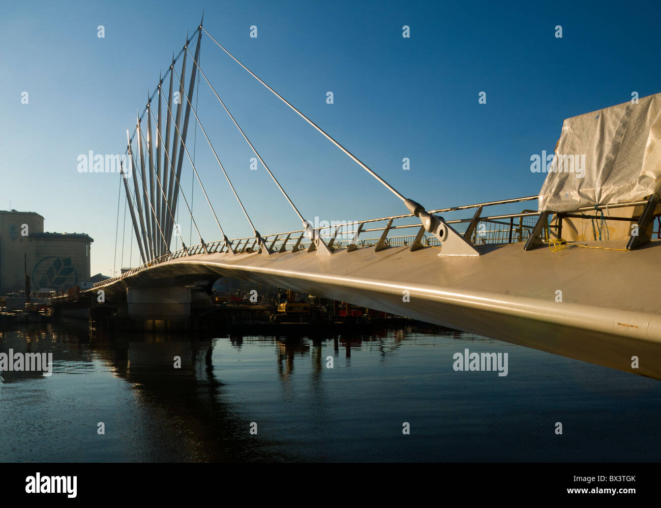 The new (2010) swing footbridge over the Manchester Ship Canal at MediaCityUK, Salford Quays, Manchester, England, UK. Stock Photo