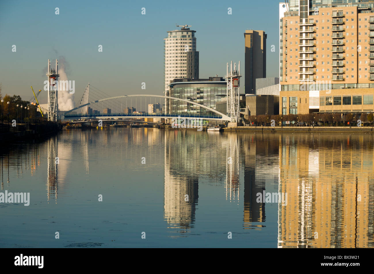 The Millennium footbridge and MediaCityUK buildings over the Manchester Ship Canal at Salford Quays, Manchester, England, UK Stock Photo