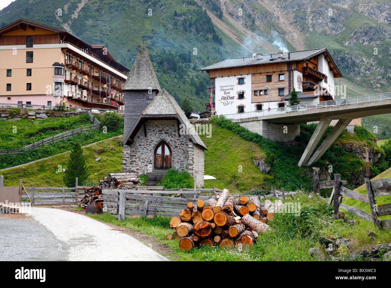 Hotel, apartment house and Catholic chapel in the charming Austrian alpine village Vent near Sölden, Ötztal, Austria. Stock Photo