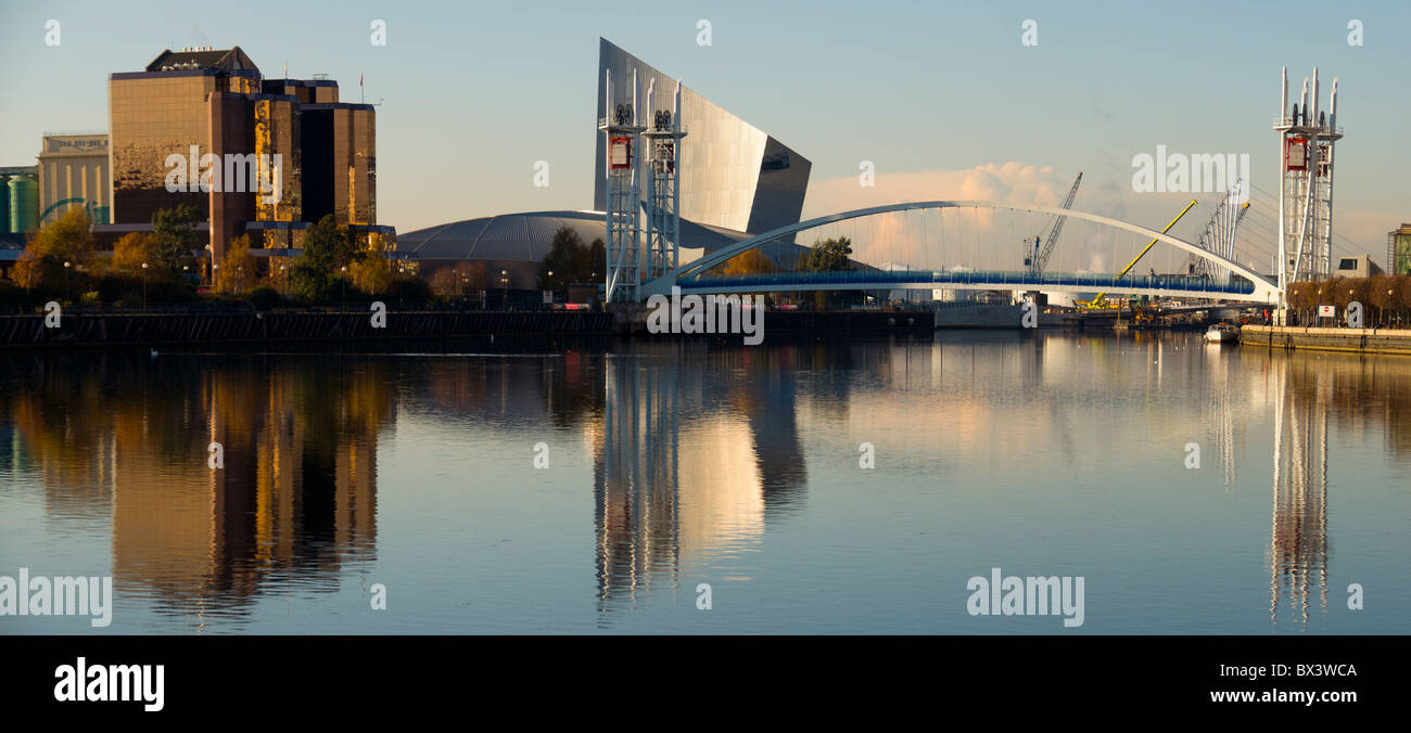 The Quay West building, Imperial War Museum North and the Millennium footbridge at Salford Quays, Manchester, England, UK Stock Photo