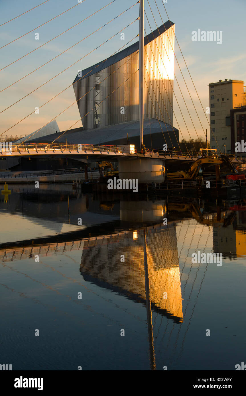 Imperial War Museum North and swing footbridge reflected in the ...