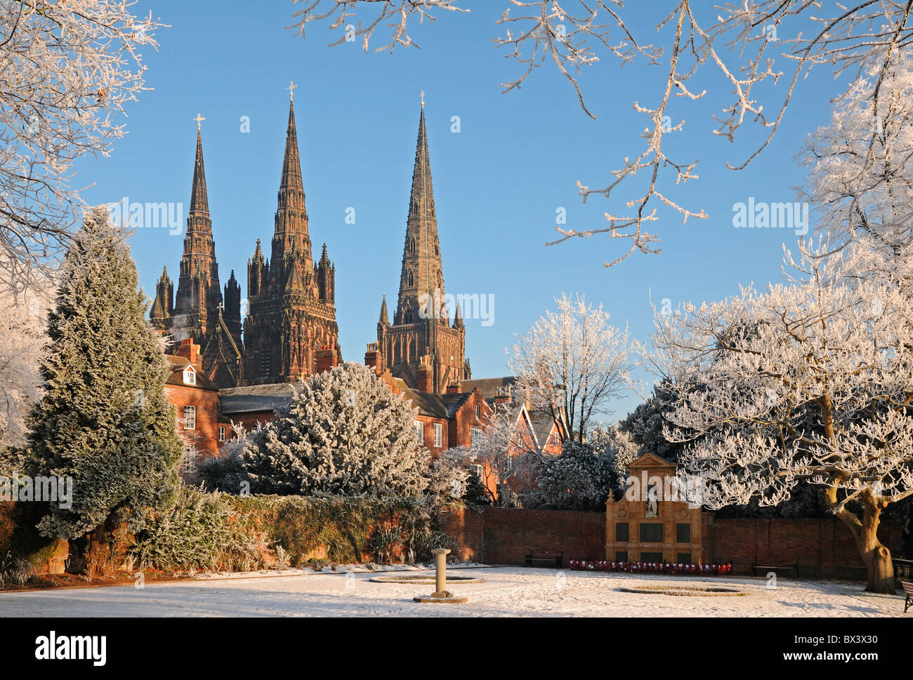 Lichfield Cathedral of St Chad with three spires seen from the Memorial Garden in winter with