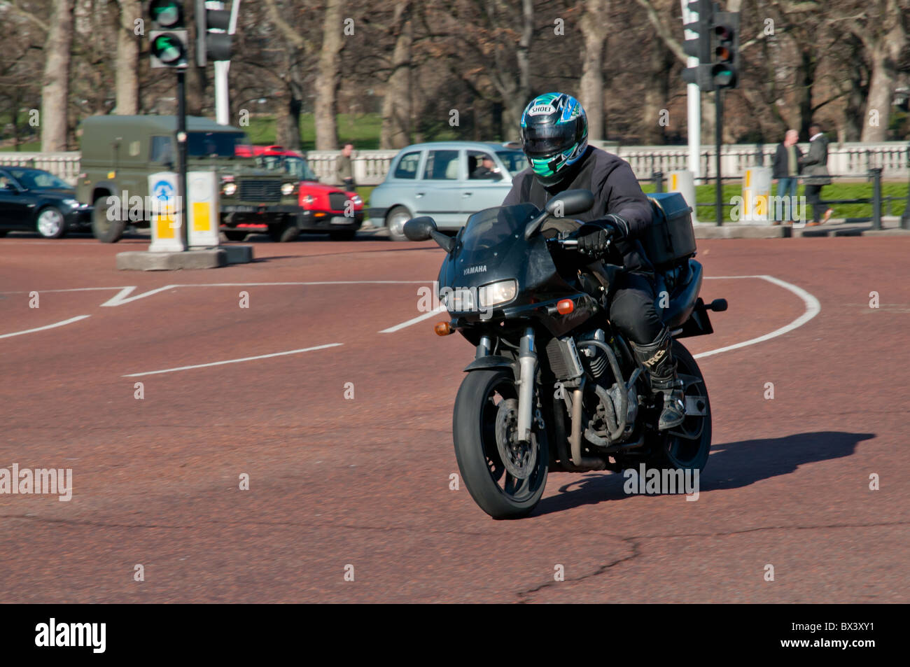 Motorcycle courier delivering in London, UK Stock Photo