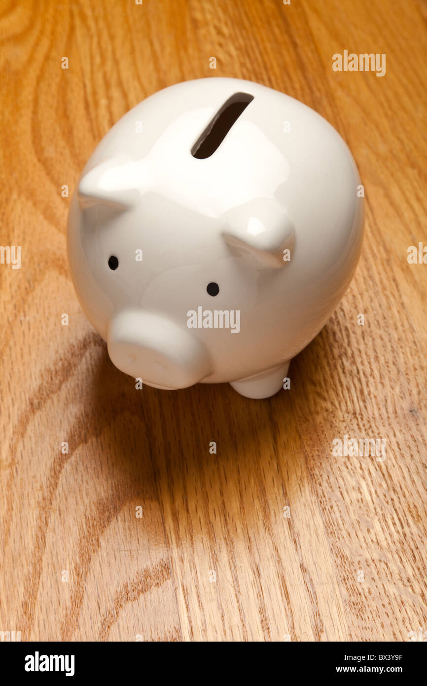 White Piggy Bank on wood table top Stock Photo - Alamy