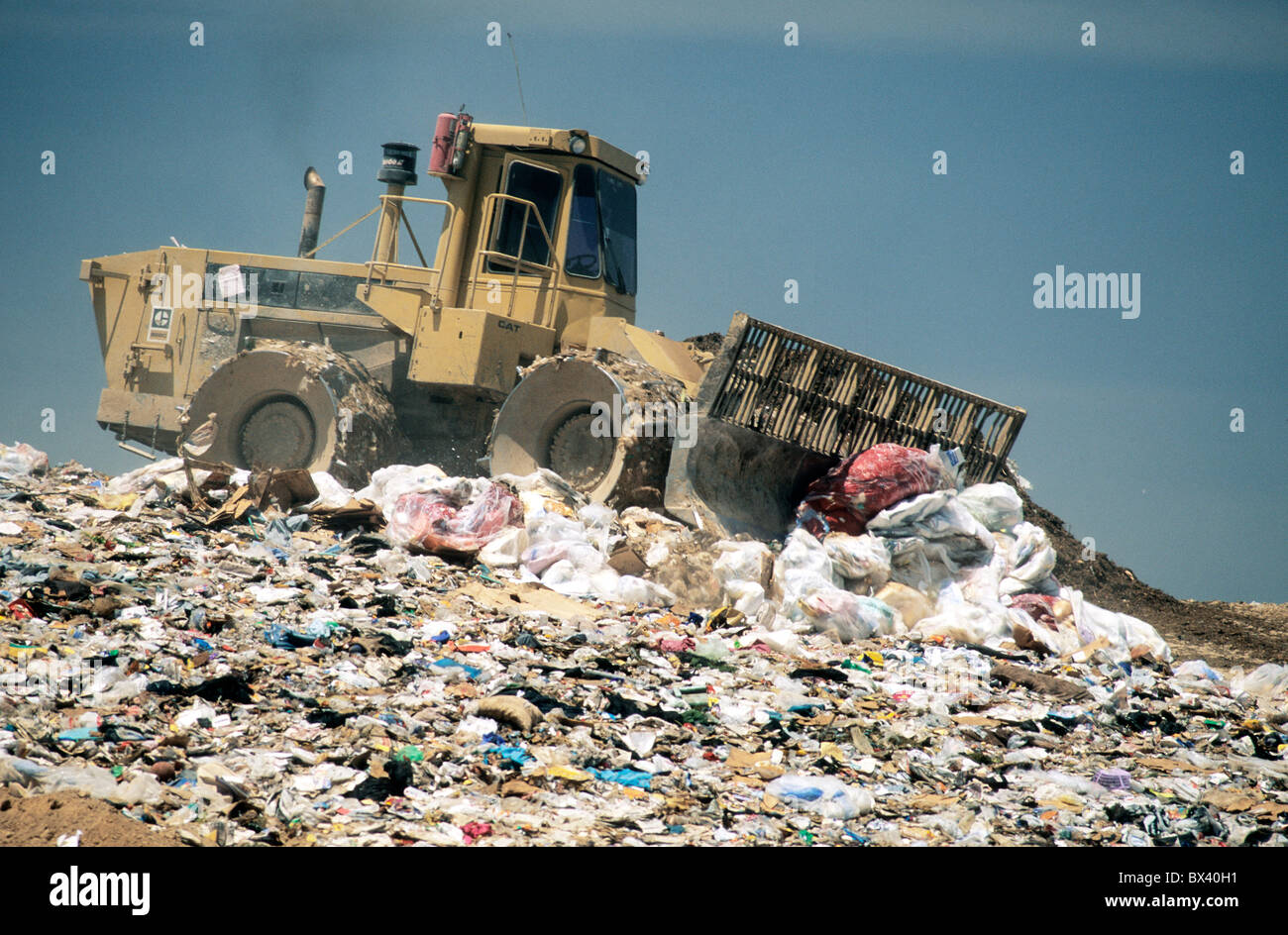 Tractor compactor/dozer '826C Cat.' self propelled with blade pushing trash. Stock Photo