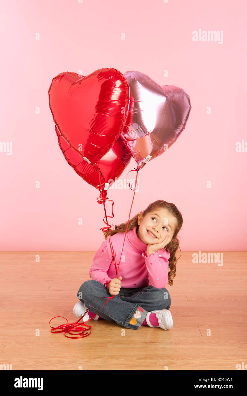 A Girl Holding Heart Shaped Balloons Stock Photo - Alamy