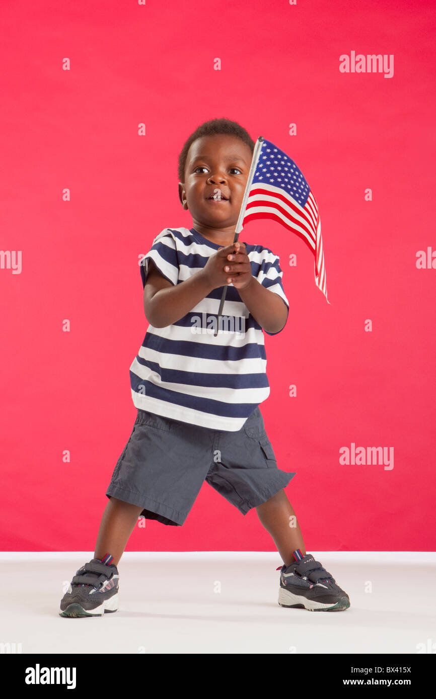 A Young Boy Holding An American Flag Stock Photo