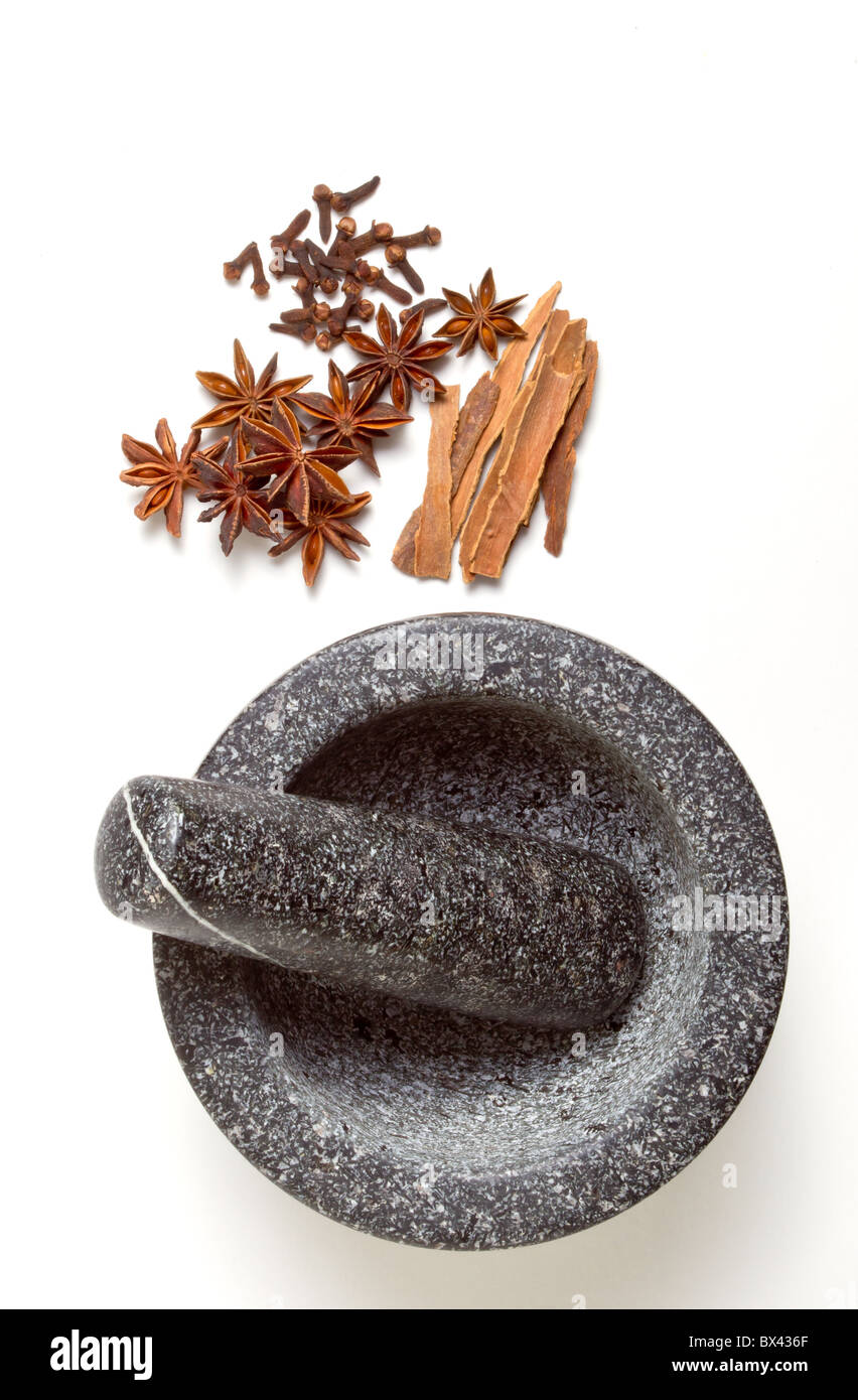 Granite mortar and pestle with winter spices of Cinnamon, cloves and Star Anise Stock Photo
