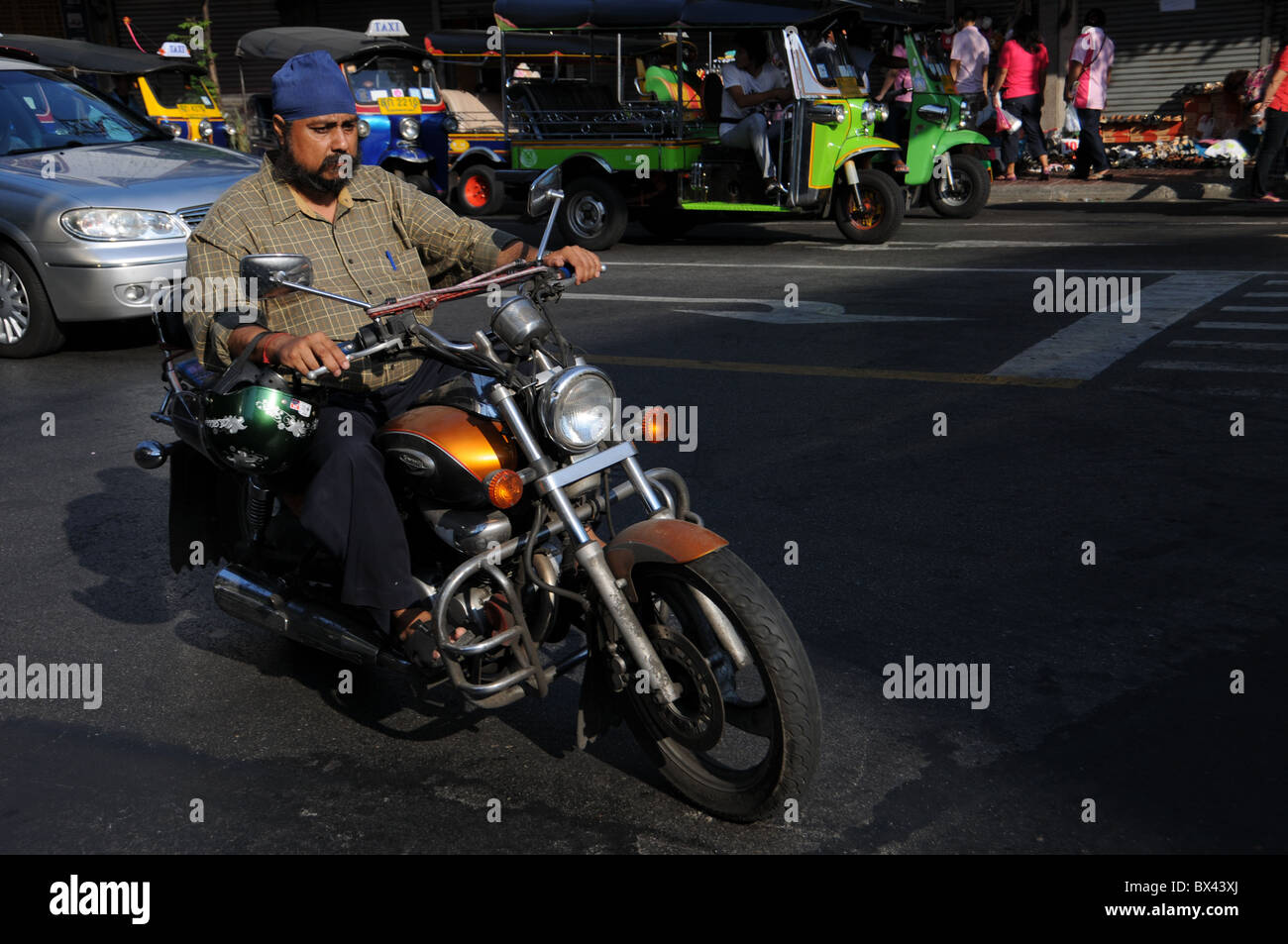 Sikh drives with a Motorbike in Bangkok Stock Photo