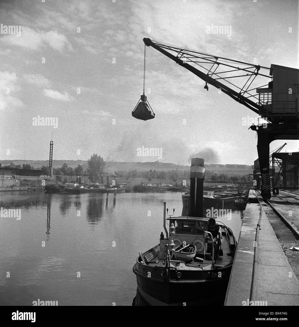Crane unloads coal from tugboats at Holesovice river port on the Vltava in Prague, August 1961. CTK Photo/Oldrich Picha Stock Photo