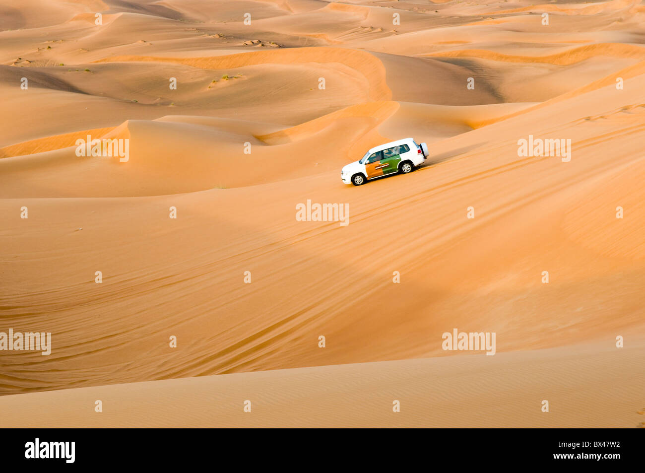 A fourwheel drive vehicle dune bashing in the desert of Dubai, United