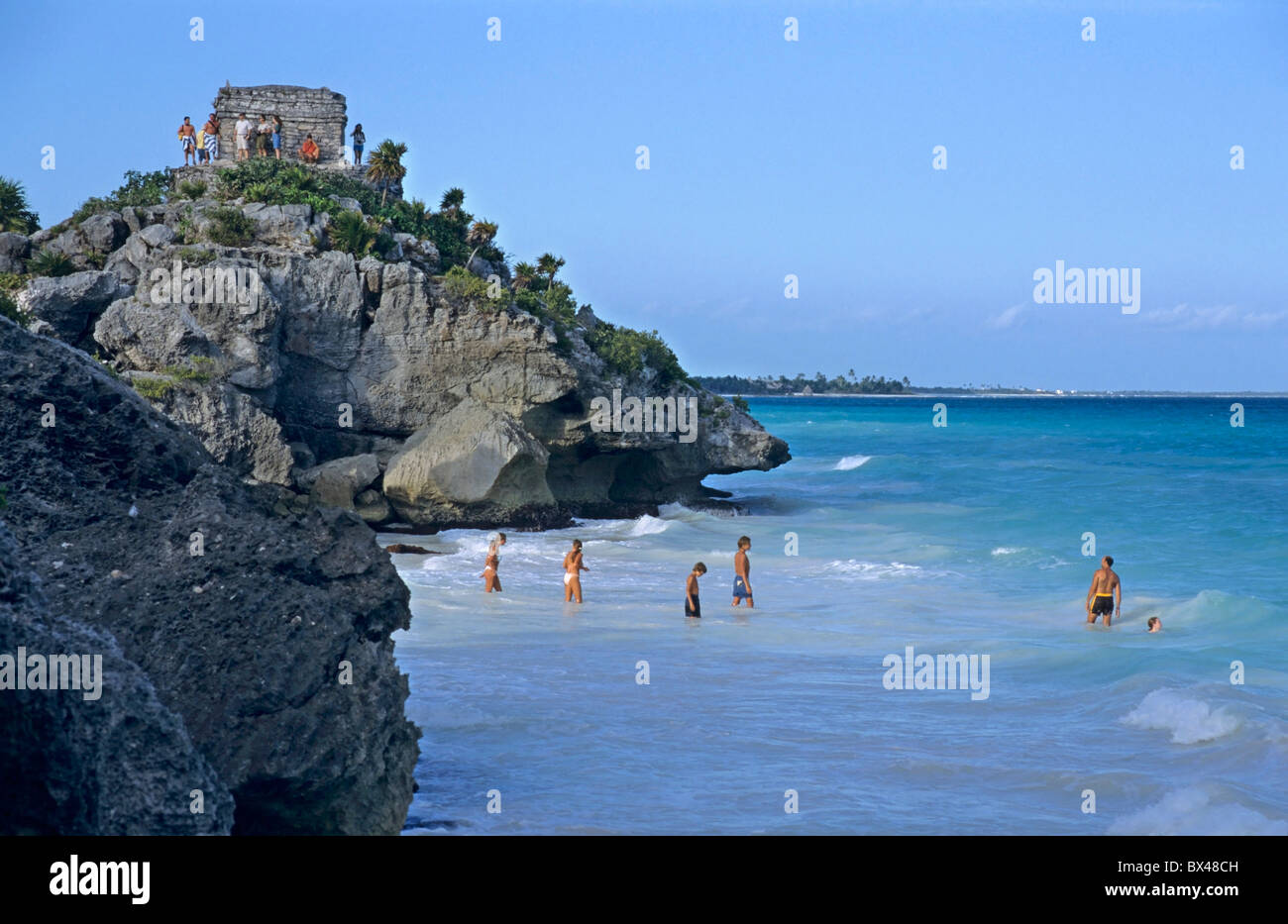 Tulum, Quintana Roo, Yucatan Peninsula, Mexico - Bathers on the beach at the foot of an ancient Mayan site - at dusk. Stock Photo