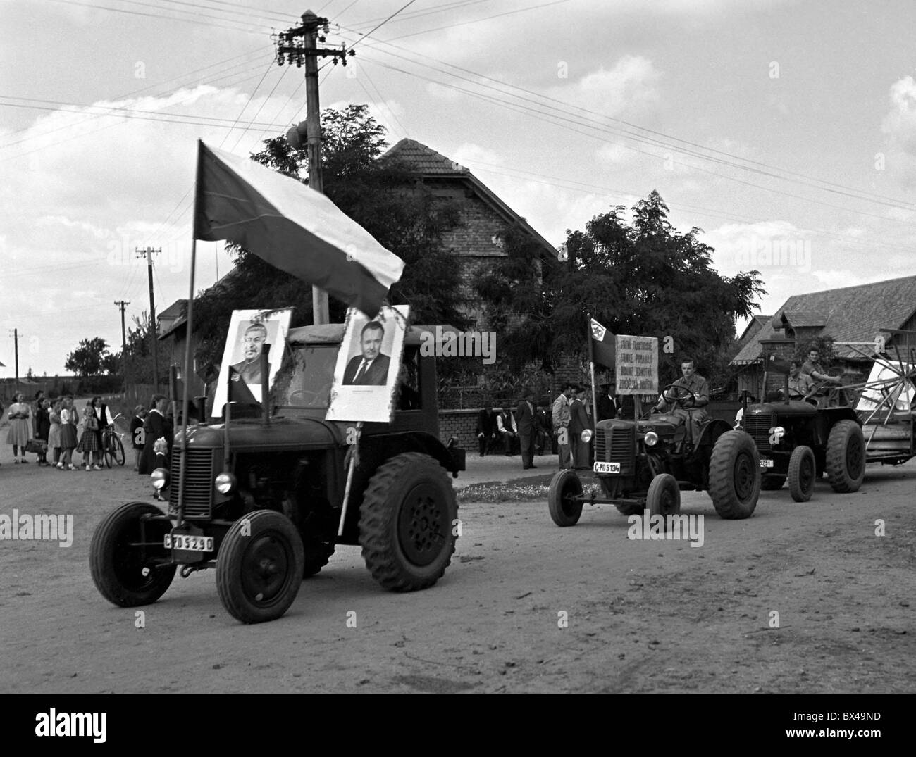 August 6th 1950 Farmer driving tractor with portraits of Czechoslovak President Klement Gottwald and General Secretary of the Stock Photo