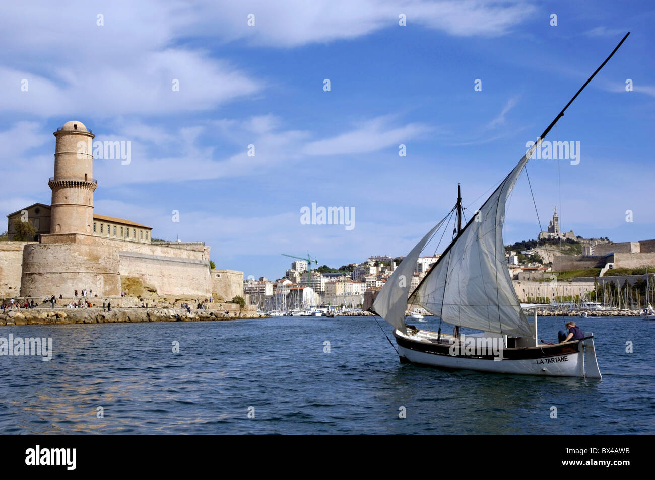 Man sailing in a yacht with Saint Jean Fort in the background, Marseille, France. Stock Photo