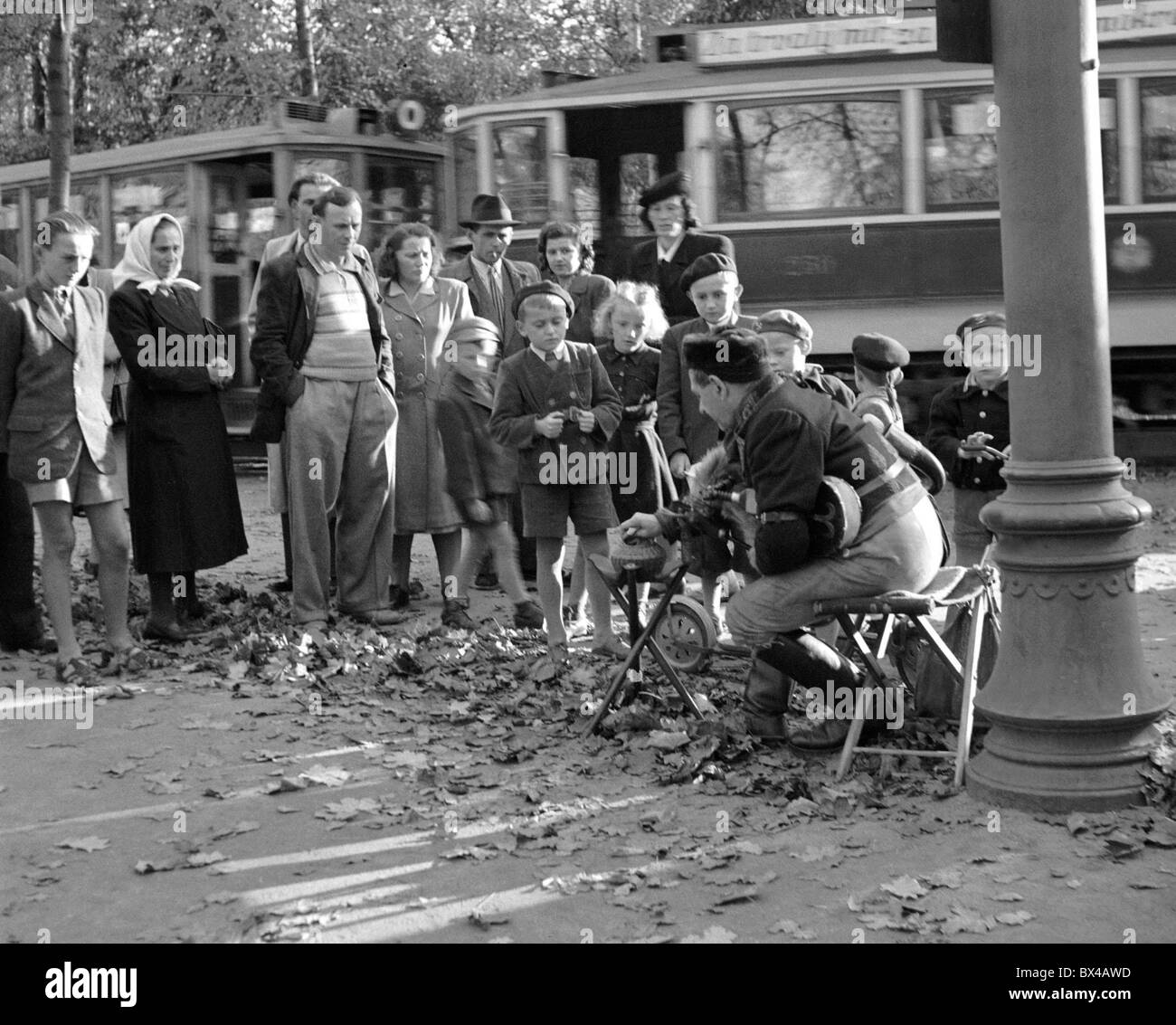 Prague, 1949. Street performer playing bagpipes draws a large crowd. CTK Vintage Photo Stock Photo